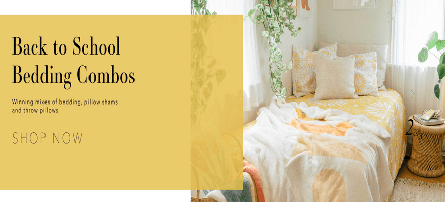 DenyDesigns homepage with a yellow bedspread